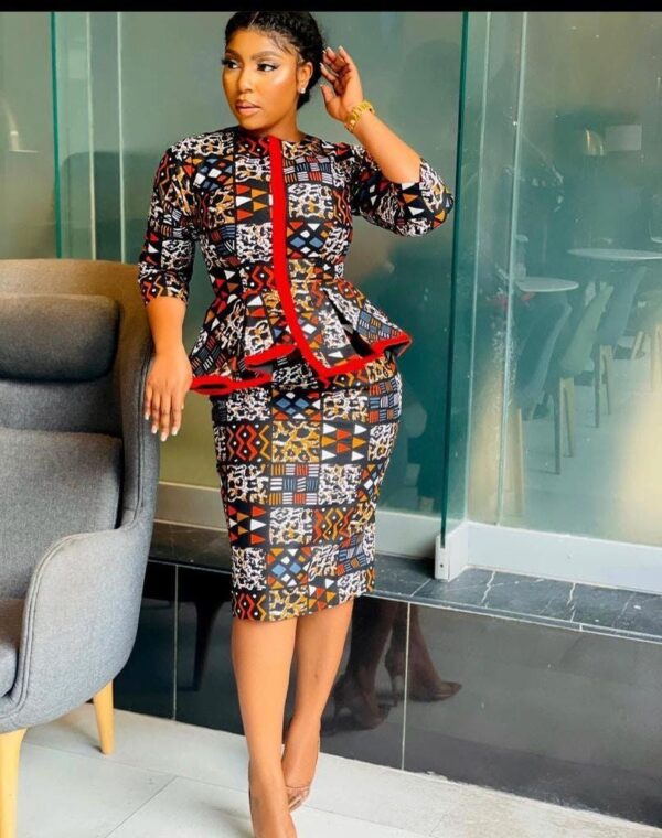 A long Ankara skirt paired with a button-up shirt and a blazer